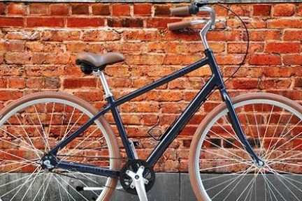 a bicycle parked in front of a brick building