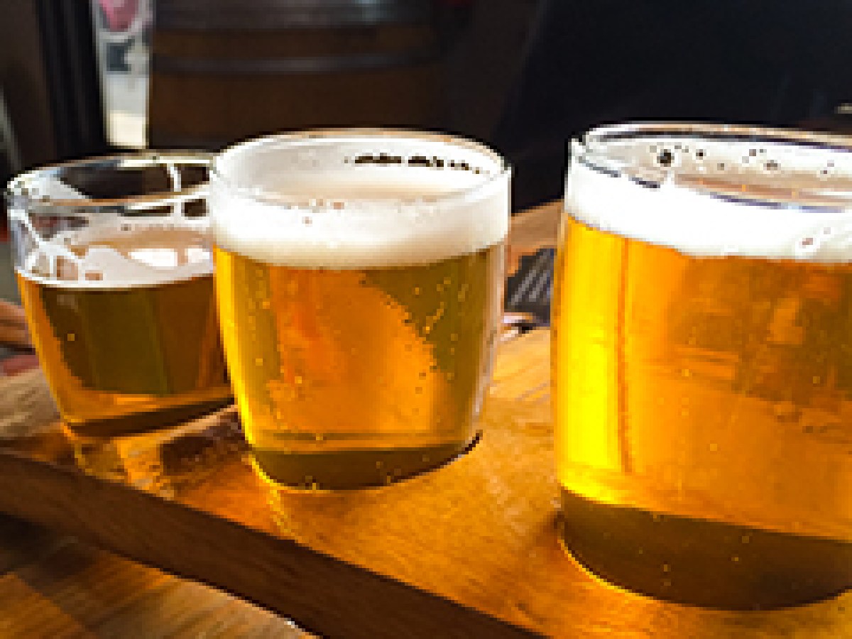 a cup of coffee and a glass of beer on a table