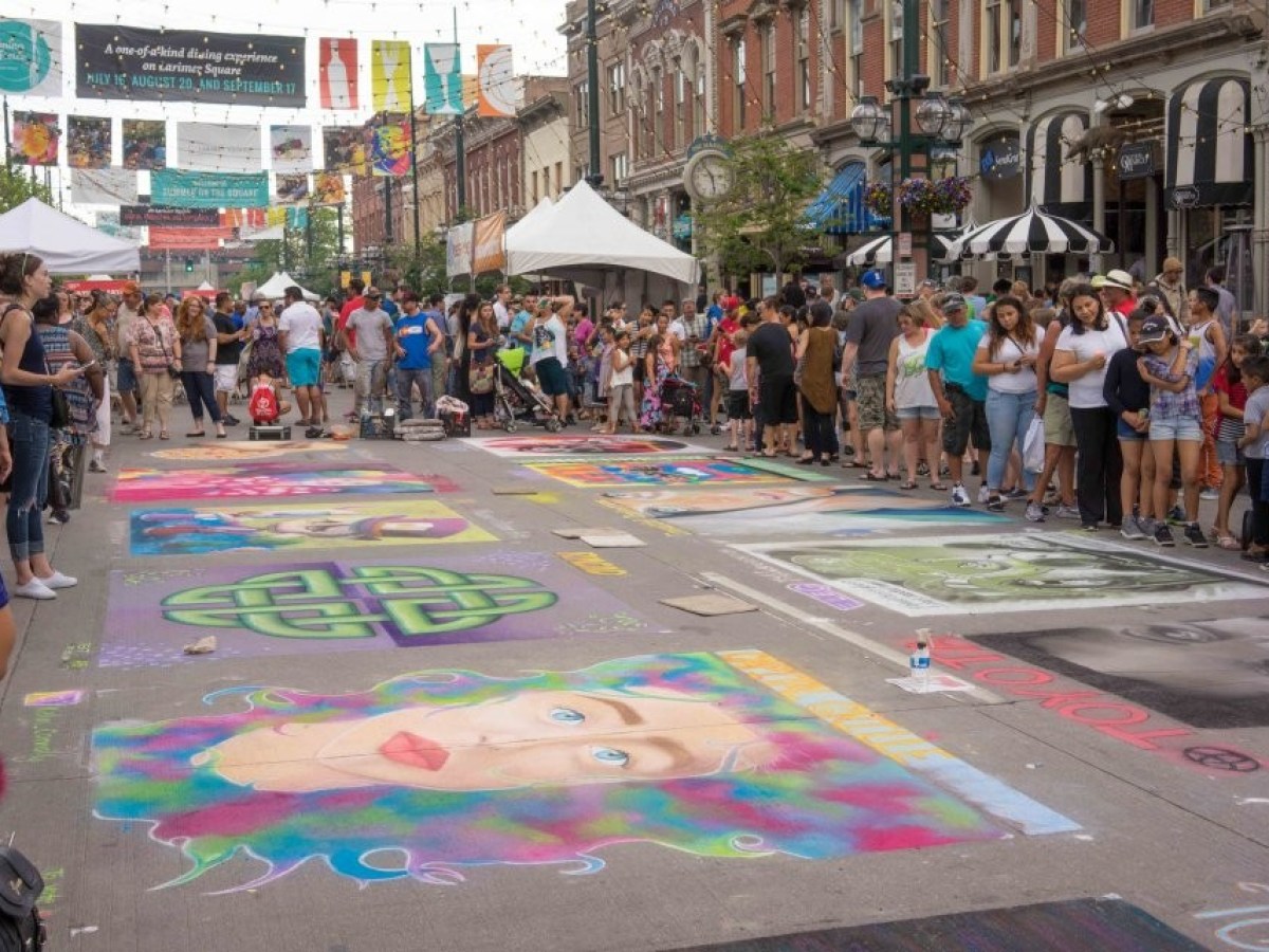 a group of people walking on a city street