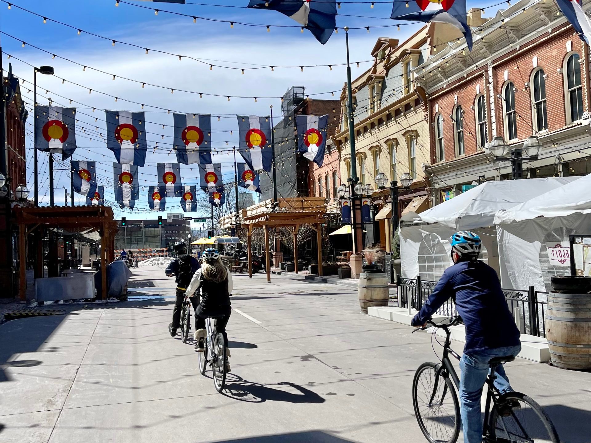 a group of people riding bikes down a street
