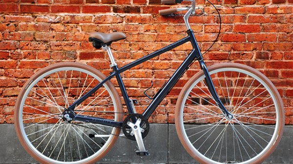 a bicycle parked in front of a brick building