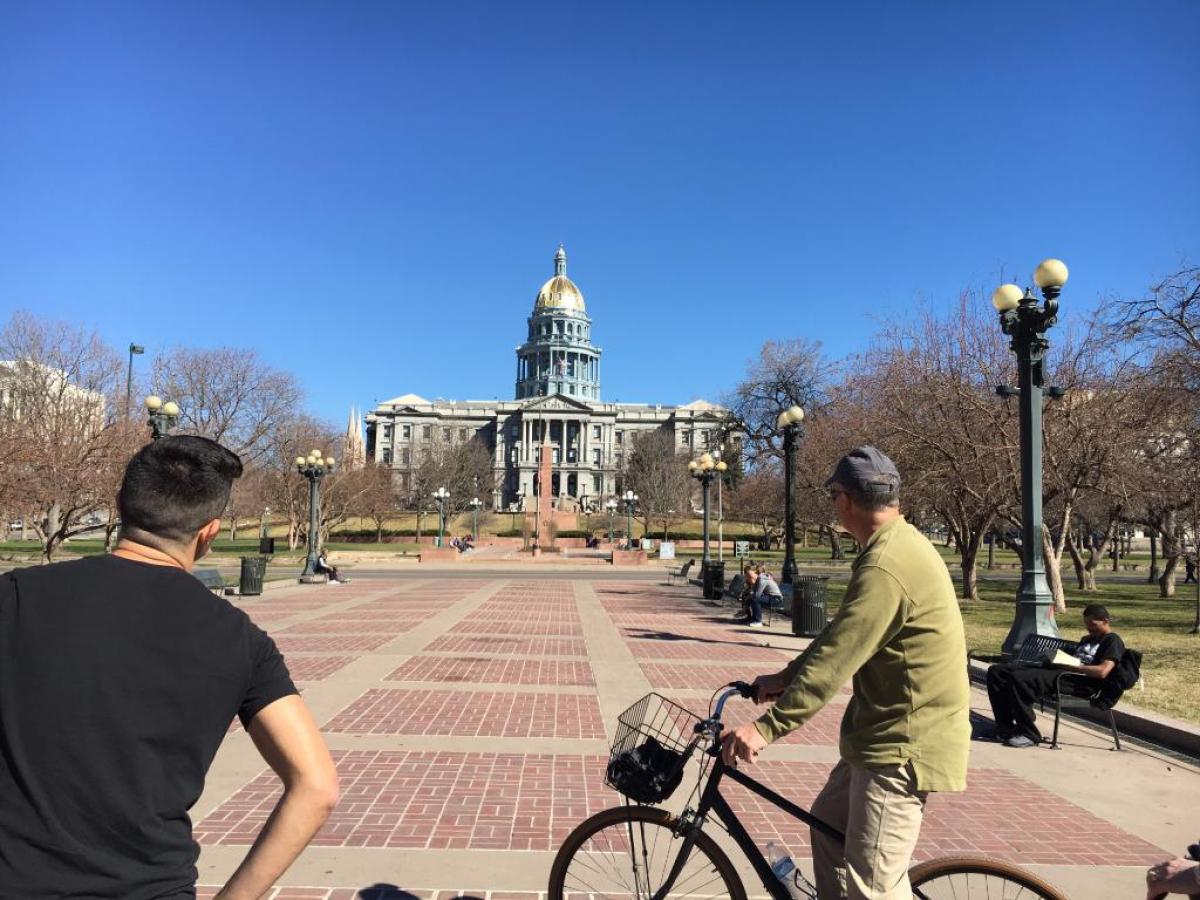 a man riding on the back of a bicycle