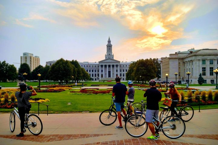 a group of people riding on the back of a bicycle