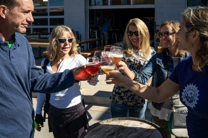 a group of people holding wine glasses